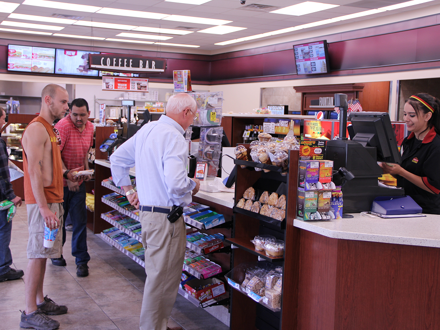 people standing at a checkout counter
