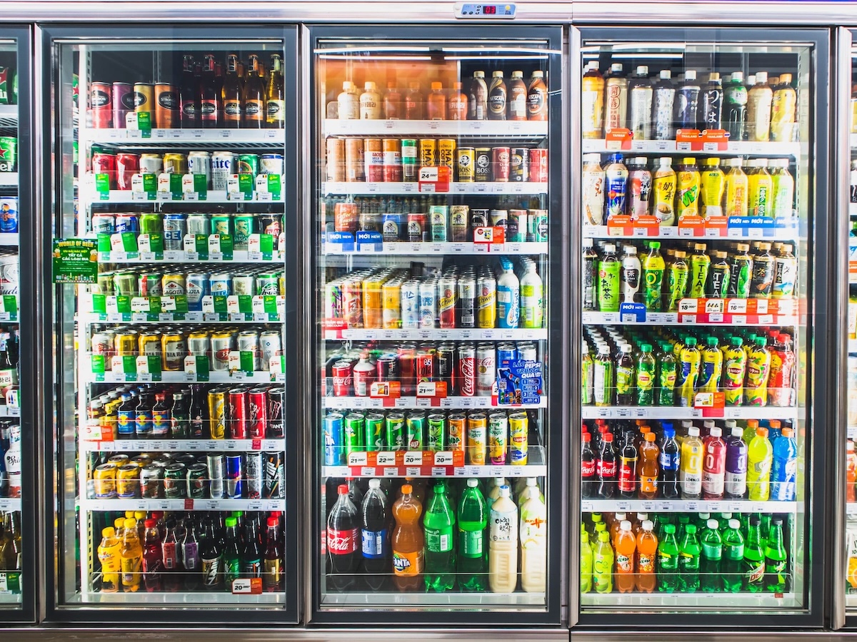A grocery store refrigerator stocked with various beverages