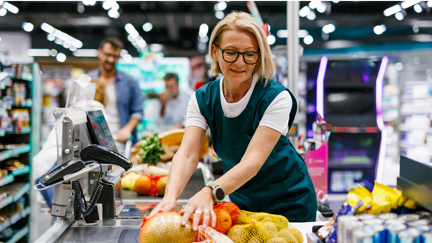 A cashier scanning groceries at a market
