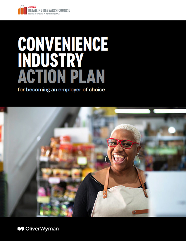 Smiling store employee wearing glasses and an apron stands in front of shelves stocked with various packaged goods inside a grocery or convenience store. report cover